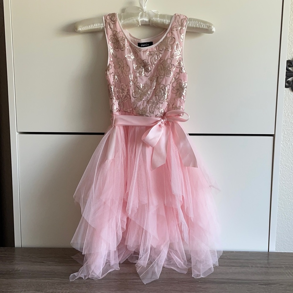 Pretty light pink girl’s dress with sequin flowers